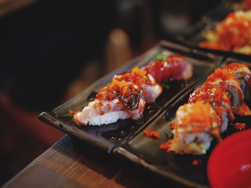 A group of people learning how to make sushi in a sushi course